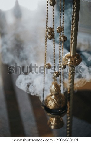 A selective focus of an orthodox church liturgy bronze incense burner