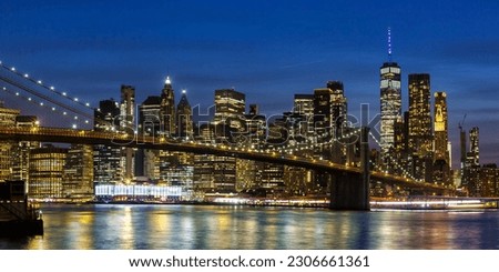 New York City skyline of Manhattan with Brooklyn Bridge and World Trade Center skyscraper at twilight night panorama in the United States