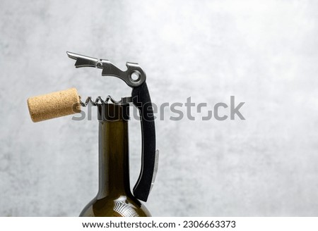 wine opener accessories tools,rose bottle and brie camembert cheese isolated gray tiles background.glass with wine,pourer, stopper, corkscrew and cork,aerator,vacuum pump.space for text.pouring red