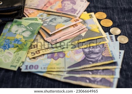 Stack of romanian polymer banknotes and coins,romanian RON currency,selective focus Royalty-Free Stock Photo #2306664965