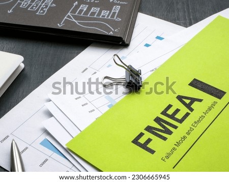 Stack of papers with FMEA failure mode and effects analysis and a pen. Royalty-Free Stock Photo #2306665945