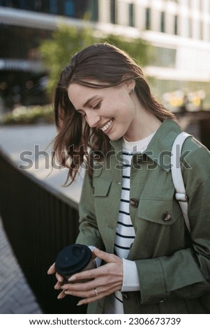 Portrait of young woman in a city.