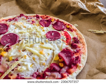 Pepperoni pizza on top of a crumpled sheet of paper. Brazilian pizza called pepperoni pizza. top view