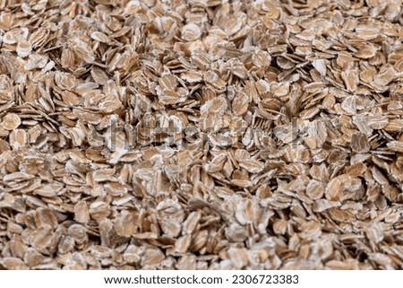 a bunch of fresh dry oatmeal flakes for making porridge, a large number of large oatmeal flakes for making breakfast Royalty-Free Stock Photo #2306723383