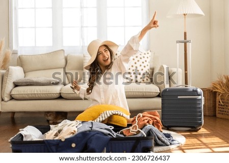 Portrait of backpacker beauty asian traveler woman packing prepare stuff and outfit clothes in suitcases travel bag luggage for summer, holiday, weekend, tourist, journey, vacation trip at home.travel Royalty-Free Stock Photo #2306726437