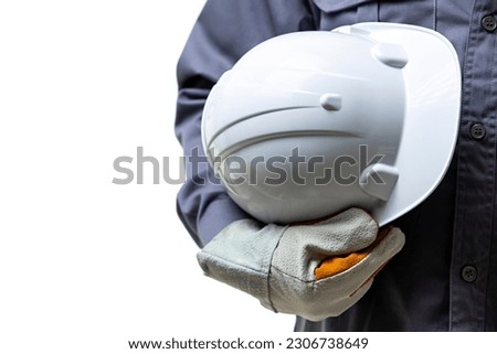 A man construction worker in gloves holding white helmet isolated on white background in studio Royalty-Free Stock Photo #2306738649