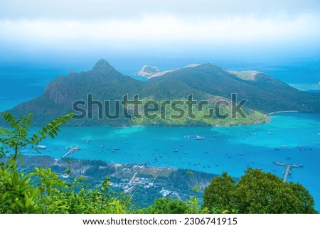 Top view Panoramic coastal Con Dao island view from above, with waves, coastline ,clear sky and road, blue sea and mountain. New passenger port of Con Dao. Royalty-Free Stock Photo #2306741915