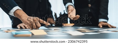 Analyst team use sticky note for financial insight with business Fintech papers for data analysis dashboard. Creative and analytic teamwork idea brainstorming for strategic business marketing. Prodigy