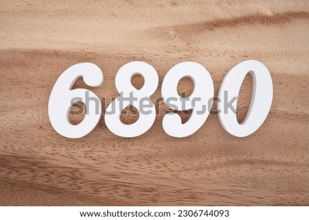 White number 6890 on a brown and light brown wooden background.