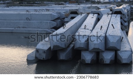 A group of concrete blocks are on the water
