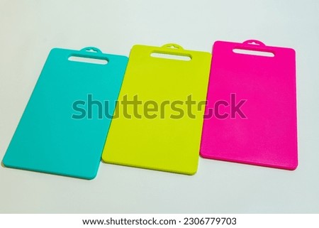 The Blue, Yellow, and Pink Plastic Cutting Board is a set of vibrant and practical kitchen essentials. Royalty-Free Stock Photo #2306779703