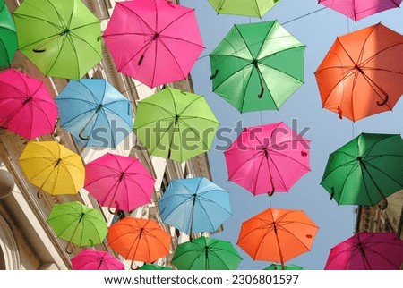 Umbrellas colorful street decoration above the roof 
