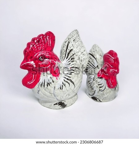 two piggy banks in the form of chickens on a white background