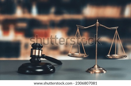Shiny golden balanced scale and wooden gavel in law firm or lawyer office background as concept justice and a common legal symbol. Scale balance for righteous and equality judgment. Equilibrium