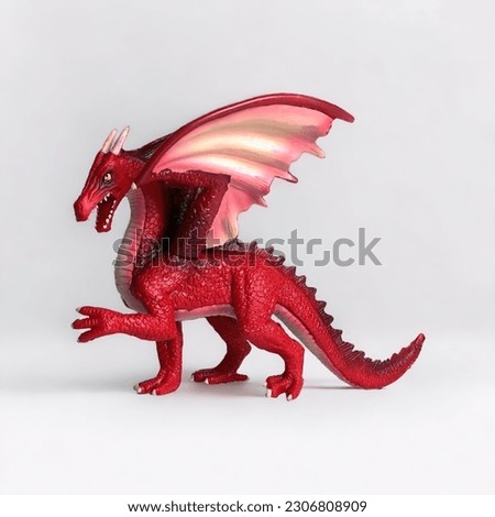Mini figure toy of a dragon on a white background