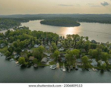 Late afternoon aerial photo of Lake Mahopac located in Town of Carmel, Putnam County, New York.	
