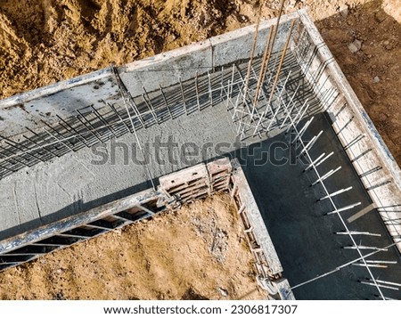 Monolithic reinforced concrete foundations or grillages for the construction of a large modern residential building. Rostverk at the construction site. Foundation for the building. View from above Royalty-Free Stock Photo #2306817307
