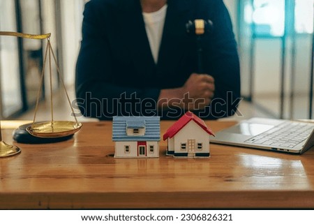 Consultation, contract agreement, lawyer focused on court hammer sitting on chair with client's indictment to settle home and land in court house auction concept