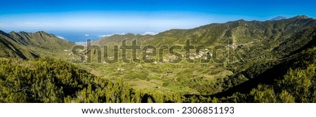 Panoramic high angle view of Palmar Valley, a fertile oasis within the Teno Mountains, a destination for travelers in search of natural beauty, tranquil charm and Tenerife's rich agricultural heritage