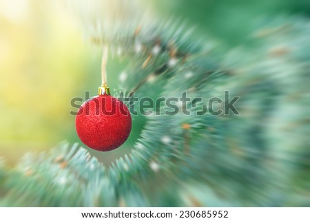 Red bauble on Christmas tree (xmas ball, christmas ornament)
