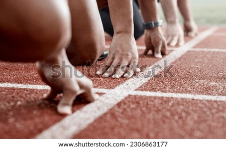 Ground, hands and people ready for a race, running competition or training at a stadium. Fitness, sports and athlete runners in a line to start a sprint, exercise or challenge in track or athletics Royalty-Free Stock Photo #2306863177