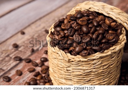 coffee beans roating on the wooden table background with copy space