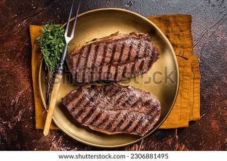 Grilled Shoulder Top Blade or Australia wagyu oyster blade beef steak. Dark background. Top View. Royalty-Free Stock Photo #2306881495