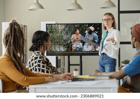 Teacher showing film in English to students Royalty-Free Stock Photo #2306889021