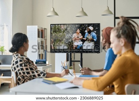 Students watching film in English in class Royalty-Free Stock Photo #2306889025