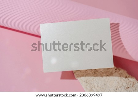 White glitter wedding invitation mockup on pink background top view. Folded business card mock up, name card, place card. Birthday card template