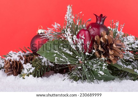 Christmas holiday decoration laying in snow with red background 