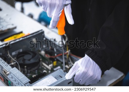 A technician is repairing a computer by replacing it. power supply computer