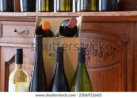 Wine bottles on wooden shelf in wine store, restaurant, cafe, bar and ready for home delivery