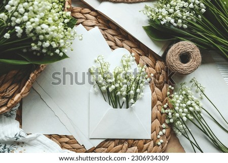 Envelope with lilies of the valley and aesthetic decor, holiday concept.