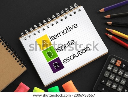 ADR - Alternative Dispute Resolution acronym on notepad, business concept background Royalty-Free Stock Photo #2306938667
