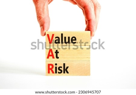 VAR Value at risk symbol. Concept words VAR Value at risk on beautiful wooden block. Businessman hand. Beautiful white table white background. Business and VAR Value at risk concept. Copy space.