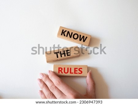 Know the rules symbol. Wooden blocks with words Know the rules. Beautiful white background. Businessman hand. Business and Know the rules concept. Copy space.