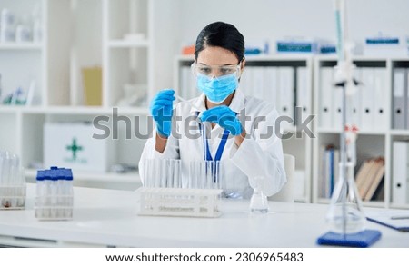 Covid, science and research with a woman in laboratory for innovation or modern medical breakthrough. Healthcare, medicine and vaccine with a female scientist working in a lab for cure development Royalty-Free Stock Photo #2306965483