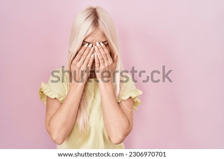 Caucasian woman standing over pink background rubbing eyes for fatigue and headache, sleepy and tired expression. vision problem 