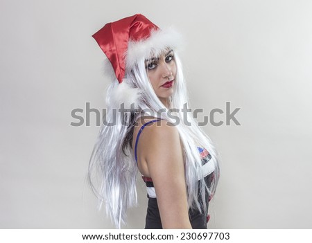 Beautiful girl wearing Santa Claus hat and looking
