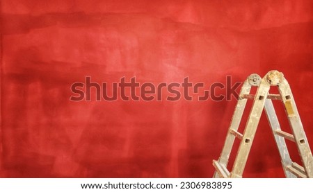 ladder on the background of a red wall