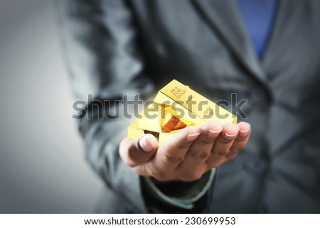 Golden bars on the woman's hand Royalty-Free Stock Photo #230699953