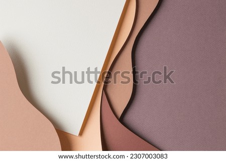 Abstract colored paper texture background. Minimal paper cut style composition with layers of geometric shapes and lines in shades of beige and brown colors. Top view