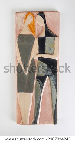 Man and woman, lovers. Made of ceramic. Ceramic plaque with sculptures of a woman and a man. Royalty-Free Stock Photo #2307024245