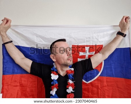 attractive man posing near white background with slovak flag. boy fanning or cheering to his national hockey team. ice hockey world championships. Royalty-Free Stock Photo #2307040465