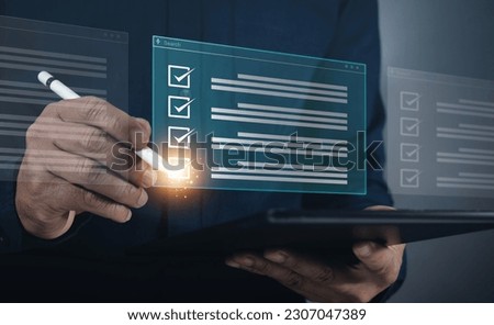 Quick Checklist and Clipboard Management Concepts business people checklist questionnaire evaluation form Checking laptop performance and completing online surveys Effective Assessment Management Royalty-Free Stock Photo #2307047389