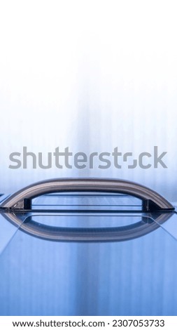 Background with glass reflections of a door handle, abstract clean calm minimalist backdrop with cool colors, concepts for ascension, rising, support, or gravity