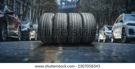 A asphalt road in on the urban street with new car tire set.