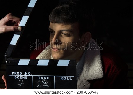 Actor ready for the ciak cinema scene during the production of short film in the night. Man inside a film set before the ciak. Portrait of a handsome man a ready to film a new scene. action hollywood 