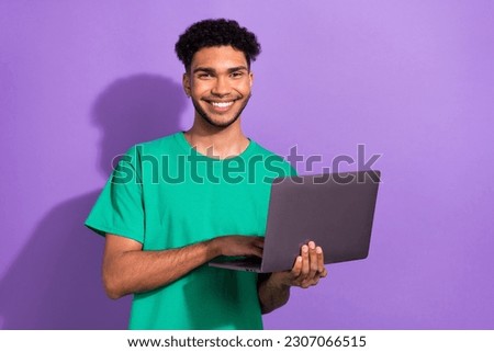 Photo of cool cheerful guy dressed green t-shirt chatting instagram twitter telegram facebook empty space isolated violet color background